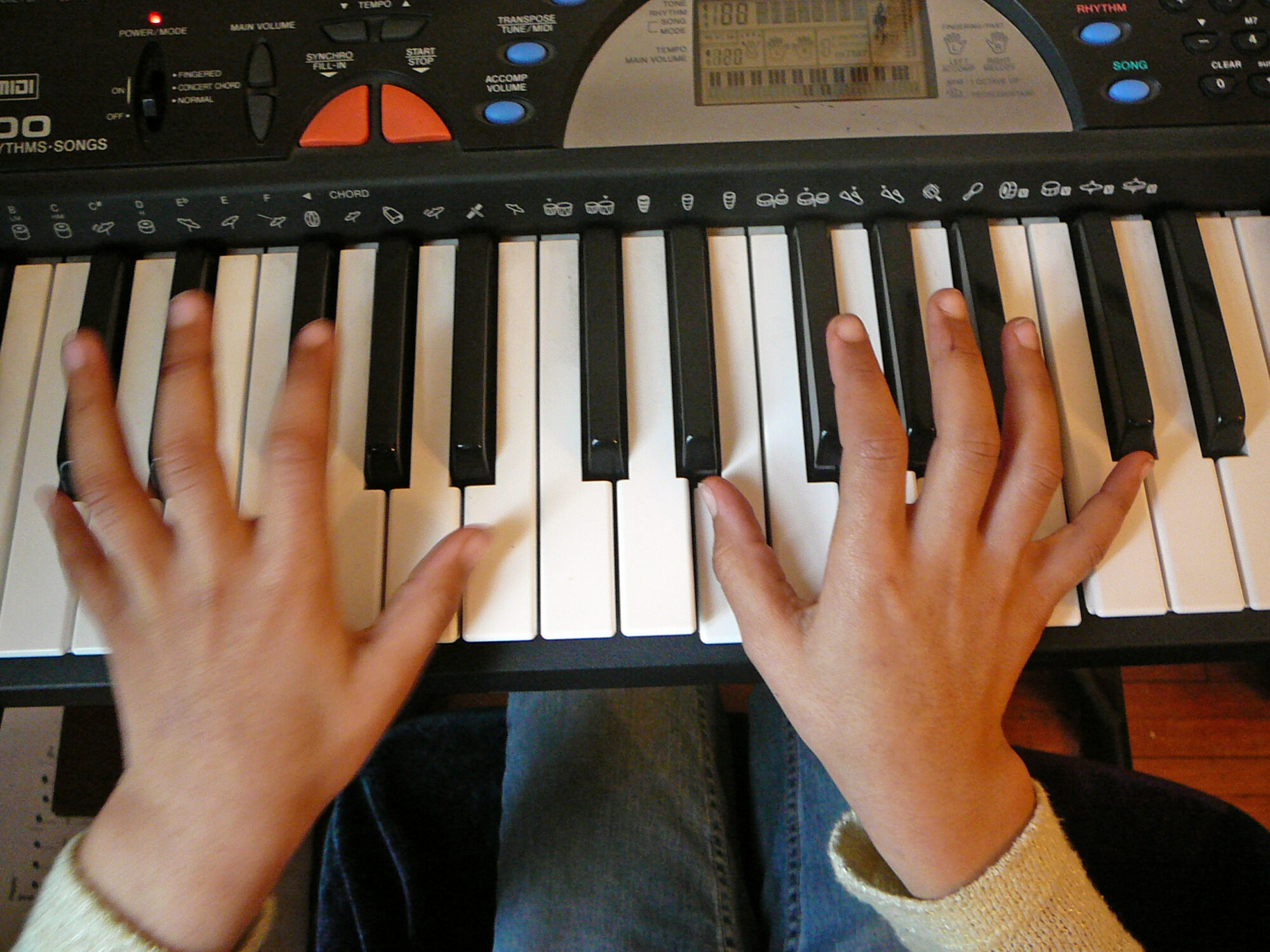 Two hands playing the keyboard