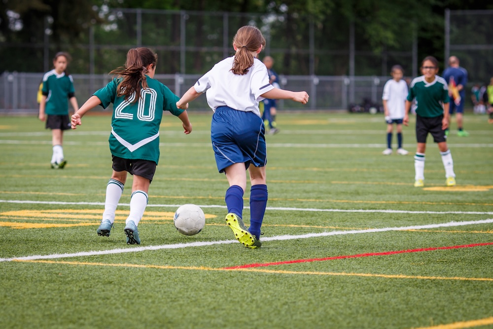 Girls playing football